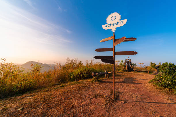 blank direction sign with pin location on pole on peak top of mountain in nature with beautiful sunrise or sunset for tourist who trek to this route stock photo