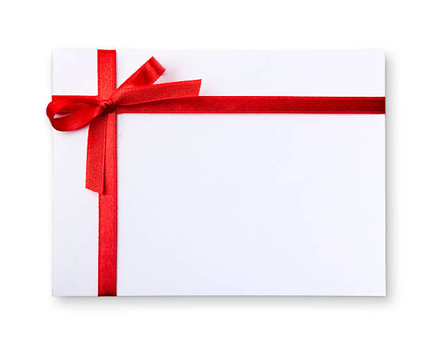 Blank gift tag tied with a bow of red ribbon stock photo