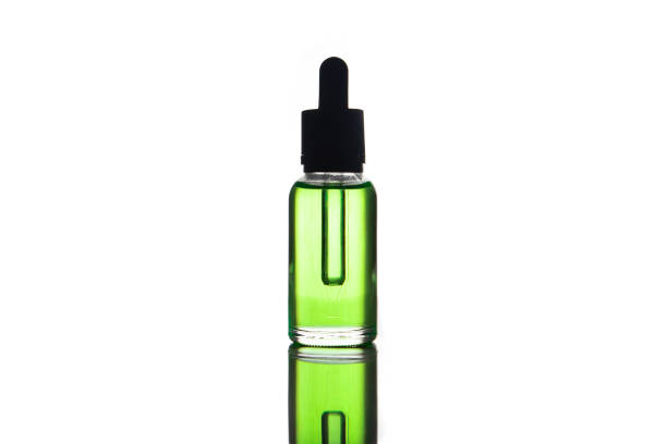 blank mock up advertising of the green e-liquid, e-juice in the bottle isolated on the white background with copy space (flacon with pipette) stock photo