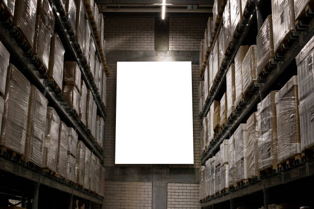 blank mockup advertising with copy space on the wall of the warehouse (storage) with rows of shelves with goods boxes stock photo