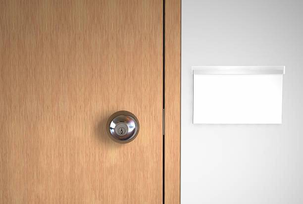 A blank name logo and a stainless door handle on wooden door stock photo
