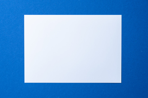 Blank paper business mock up on classic blue background, top view