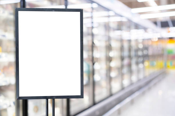 Blank poster frame template in supermarket. Blurred background stock photo