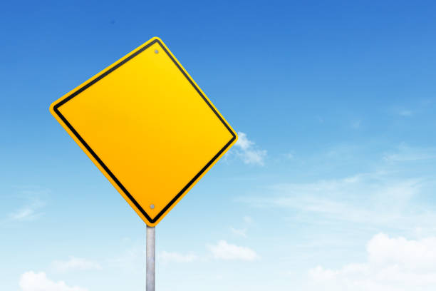 Blank road sign with copy space over blue sky stock photo