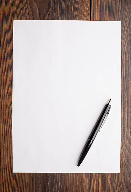 Blank sheet of white paper and pen stock photo