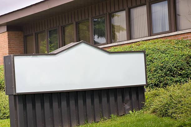 Blank sign in front of small office building stock photo