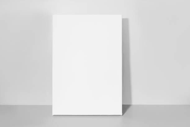 Blank vertical canvas. Mock up poster. Gray wall and floor on background. poster stock pictures, royalty-free photos & images