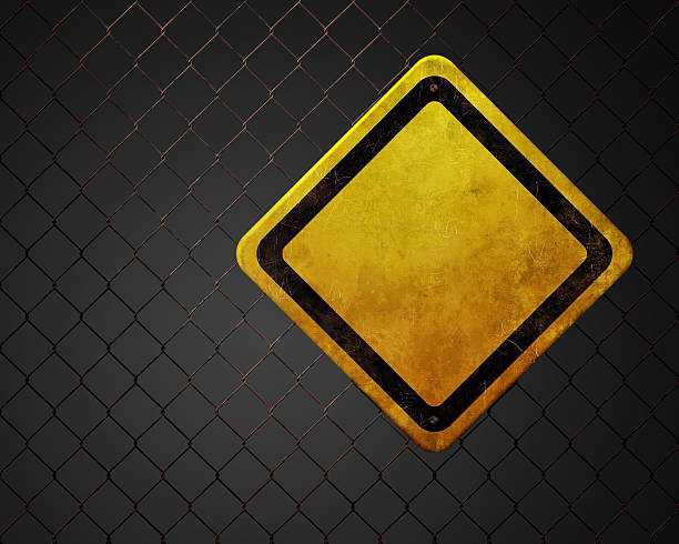 Blank warning sign at chainlink fence Grunge empty warning sign at rusty chainlink fence with copy space rusty fence stock pictures, royalty-free photos & images