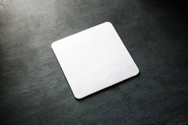 Blank white beer coasters mockup, clipping path Blank white square beer coaster mockup lying on the textured background. Squared clear design mock up top view. Quadrate cup rug display, isolated. coaster stock pictures, royalty-free photos & images