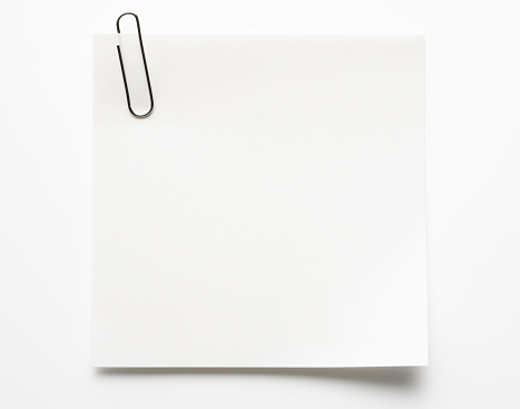 Blank white sticky note and paper clip isolated on white background with clipping path.