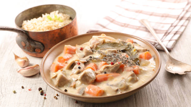 blanquette de veau, french gastronomy- veal cooked with cream,carrot and herbs stock photo