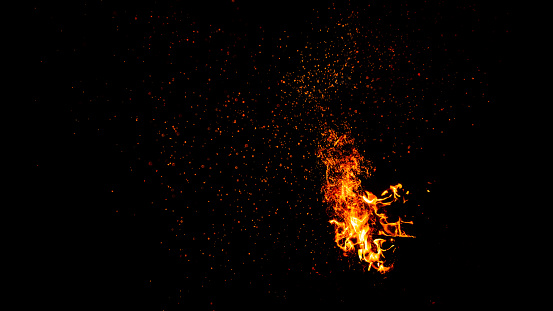 Blazing fire flame with a lot of sparks isolated on black background