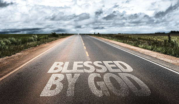 Blessed By God written on rural road stock photo