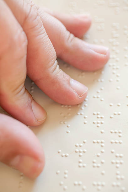 Blind reading text in braille language stock photo