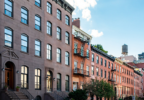 Block of old historic brownstone buildings in the Chelsea neighborhood of Manhattan in New York City NYC