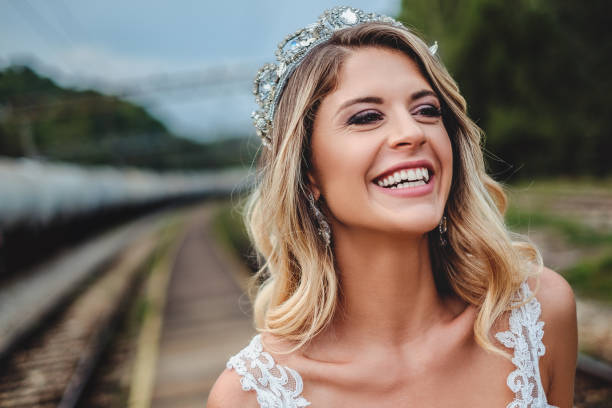 Blonde bride smiling and looking to the side stock photo