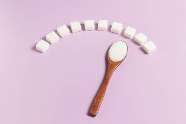 Blood sugar scale made from white sugar cubes and wooden eco spoon on light background Blood sugar scale made from white sugar cubes and wooden eco spoon on light background hyperglycemia stock pictures, royalty-free photos & images