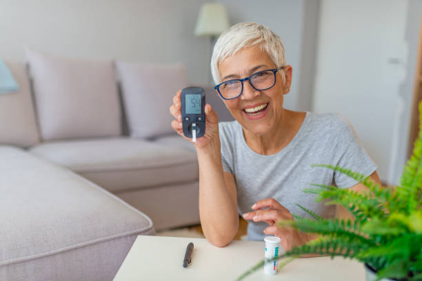 Blood sugar testing at home Blood sugar testing at home. Checking Blood Sugar Level At Home. Diabetic Checking Blood Sugar Levels. Woman checking blood sugar level by glucometer and test stripe at home diabetes stock pictures, royalty-free photos & images