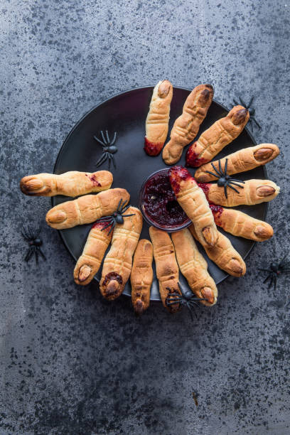 Bloody  cookies fingers for Halloween party celebration, Cookies "Witchs fingers". Dark background, food for Halloween stock photo