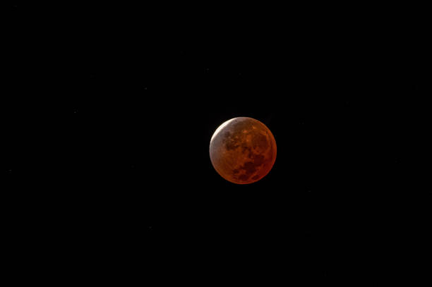 Bloody lunar eclipse. Blood red moon. Super moon in the black sky. Space view with stars. stock photo