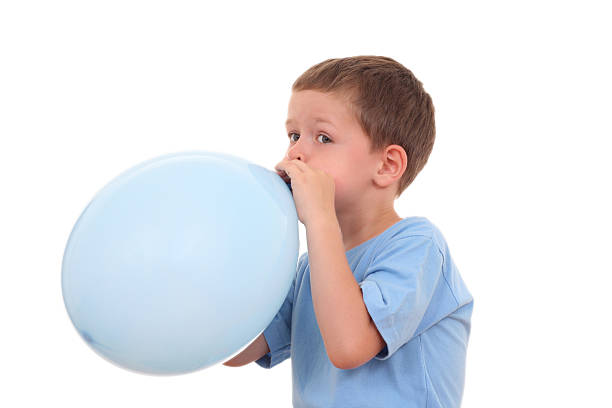 blowing up balloon stock photo