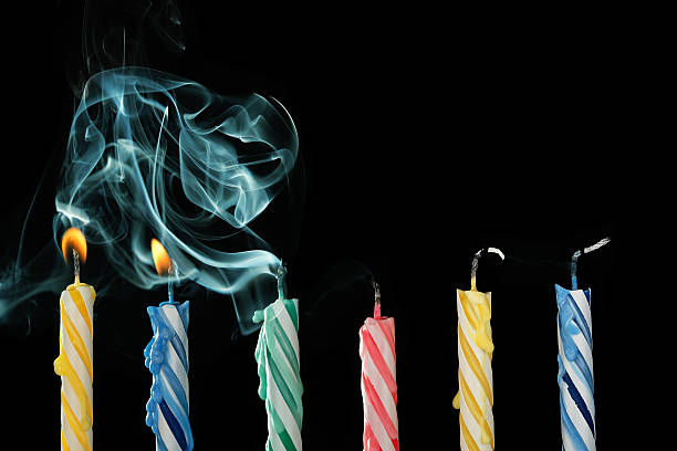 blown out candles birthday candles that have just been blown out with smoke on black background birthday candle stock pictures, royalty-free photos & images