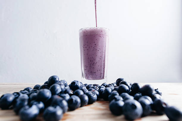 Bluberry smoothie fresh blended with fresh blueberry on summer Blueberry smoothie fresh blended with fresh blueberry on summer wood table bluberry smoothie stock pictures, royalty-free photos & images