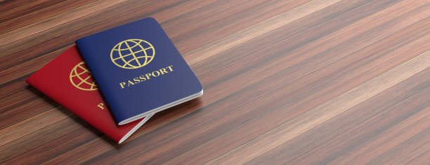 Blue and red passports isolated on wooden background, banner, copy space. 3d illustration Travelling concept. Blue and red passports isolated on wooden background, banner, copy space. 3d illustration dual citizenship stock pictures, royalty-free photos & images