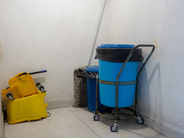 Blue and Yellow plastic buckets and janitor tools. stock photo