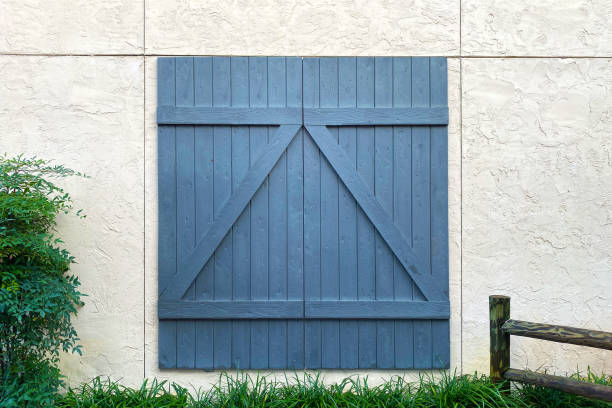 blue barn door white stone building stock photo