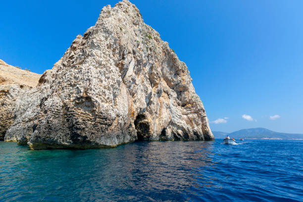 Blue Cave carved in the limestone by the Adriatic Sea, tourists sailing by boat to the grotto, Bisevo Island, Croatia stock photo