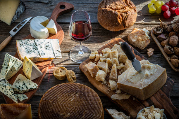 Blue cheese manchego and parmigliano reggiano Blue cheese manchego and parmigliano reggiano with wine assorted table chestnut food stock pictures, royalty-free photos & images