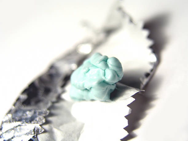 Blue chewed gum on a silver wrapper stock photo
