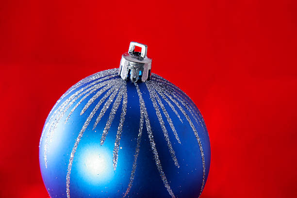 Blue christmas ball on red stock photo