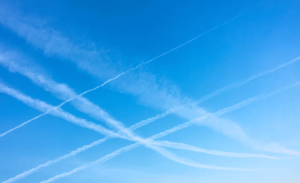 Blue clear sky with plane exhausts Blue clear sky with plane exhausts, may be used as background vapor trail stock pictures, royalty-free photos & images