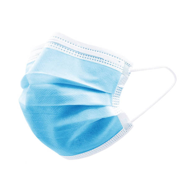 Blue colour high density 3 ply non woven disposable surgical face mask with elastic ear loops isolated on white background. Eliminates bacteria & pollen. Studio photography for mock up & commercial. protective face mask photos stock pictures, royalty-free photos & images