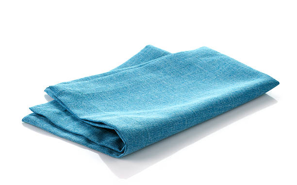 blue cotton napkin blue folded cotton napkin on a white background napkin stock pictures, royalty-free photos & images
