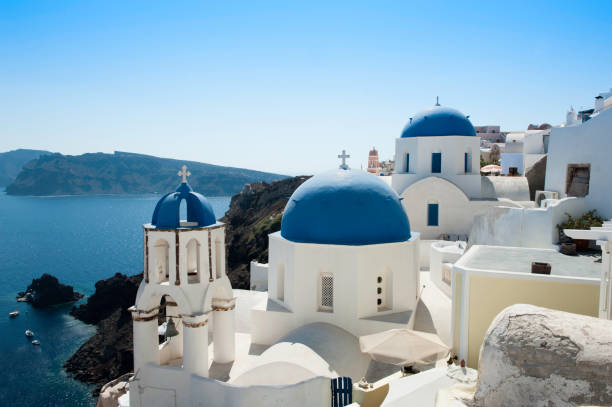 Blue domed church with white washed houses in Santorini, Greece stock photo