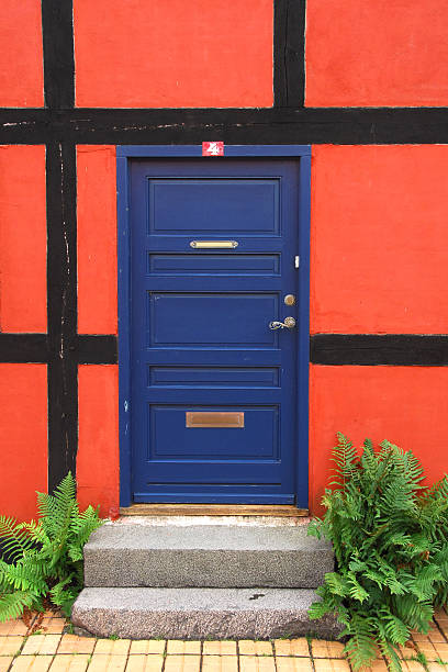 Blue door in red frame stock photo