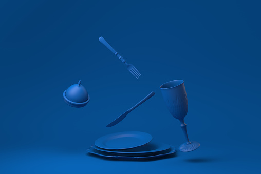 Blue Empty plate, forks, knives, spoons, set in restaurant floating in blue background. minimal concept idea creative. monochrome. 3D render.