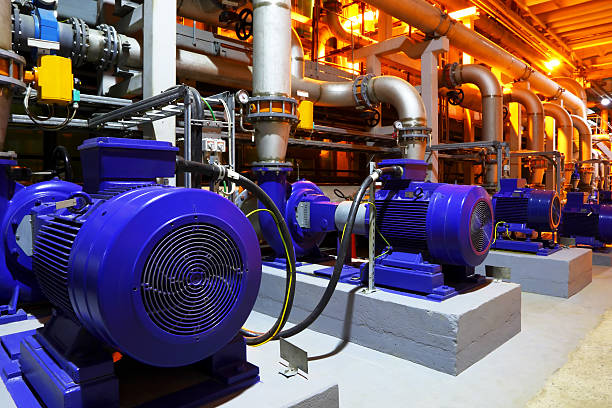 Blue factory equipment in a building Electric motors of pumps at plant electric motor stock pictures, royalty-free photos & images