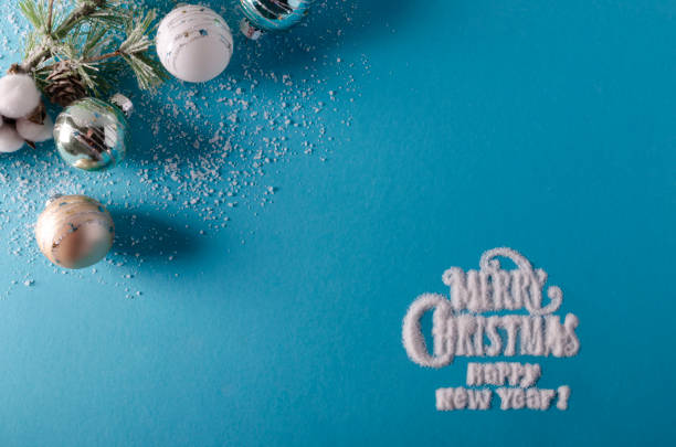 blue holiday season background with Merry Christmas and happy new year written with snow stock photo