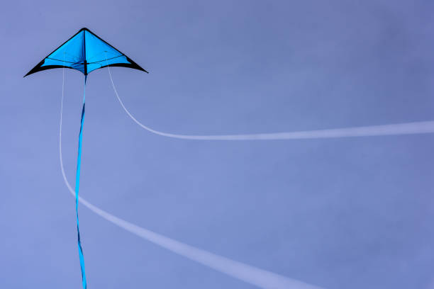 Blue kite floating in the blue sky. stock photo