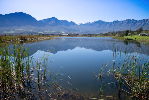 A blue lake circled by magnificent mountains in the Western Cape. stock photo