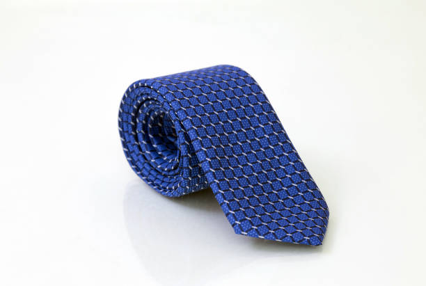 Blue mens tie Rolled blue men's tie isolated on white glassy background, closeup necktie stock pictures, royalty-free photos & images