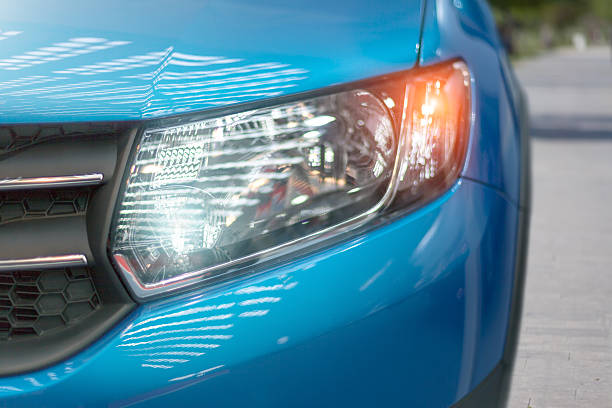 blue modern car closeup of headlight - bumper stockfoto's en -beelden