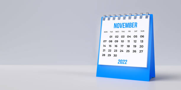 Blue November desk calendar 2022 on blank background with copy space. Monthly Set Desk Calendar 2022 template: 3D illustration on grey colored surface with large blank space for additional text. Horizontal composition. Set of 12 Months. Week starts on Monday. Stationery planner. memorial day background stock pictures, royalty-free photos & images
