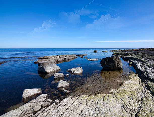 Blue ocean rocky shore stock photo