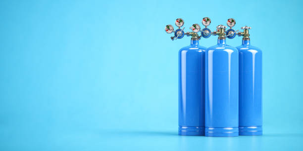 Blue oxygen tanks or cylinders on blue background. stock photo