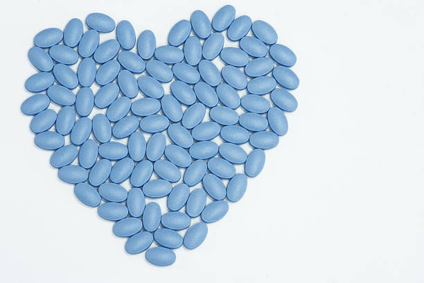 Blue Pills of Love An arrangement of little blue pills into a heart, on white. Ample copy space. My 61st Flame on January 29th, 2009. Thanks! Check out some other white backgrounds here. anti impotence tablet stock pictures, royalty-free photos & images